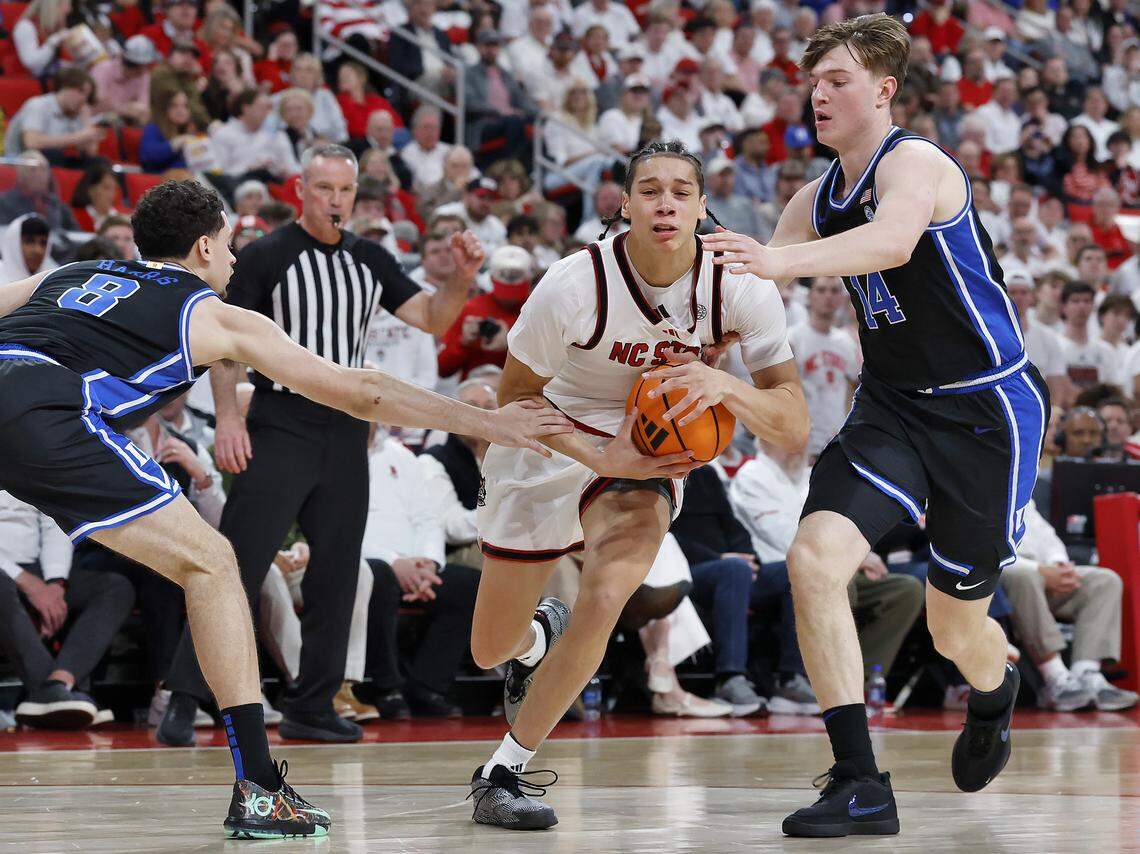 N.C. State’s Matt Able drives between Duke’s Darren Harris and Duke’s Nikolas Khamenia during the second half of the Wolfpack’s 93-64 loss on Monday, March 2, 2026, at Lenovo Center in Raleigh, N.C. 
