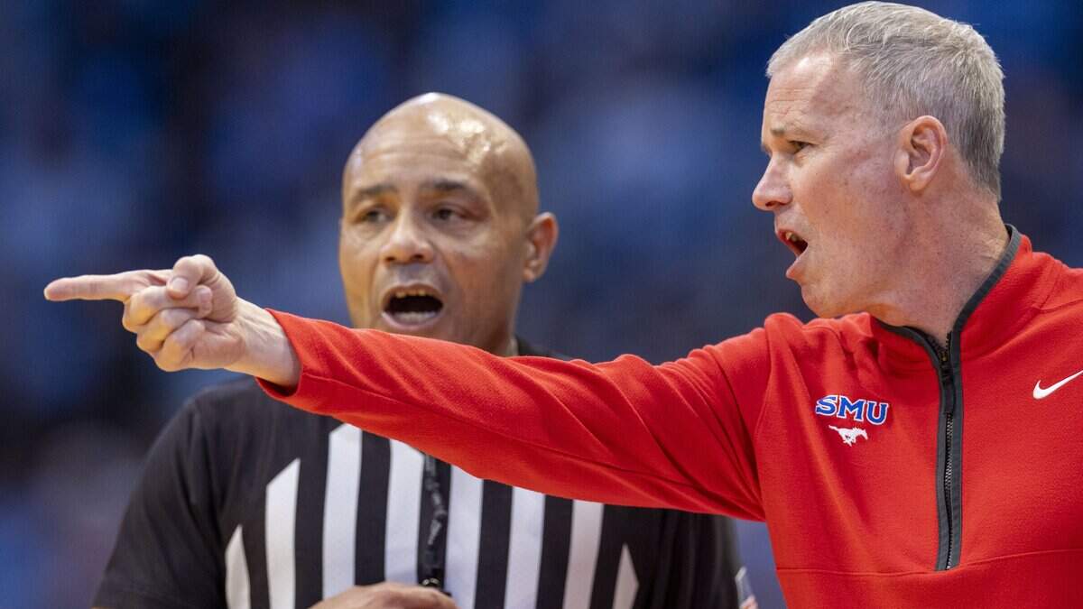 SMU coach Andy Enfield argues with official Bill Covington 
in the first half against North Carolina on Tuesday, January 7, 2025 in Chapel Hill, N.C.