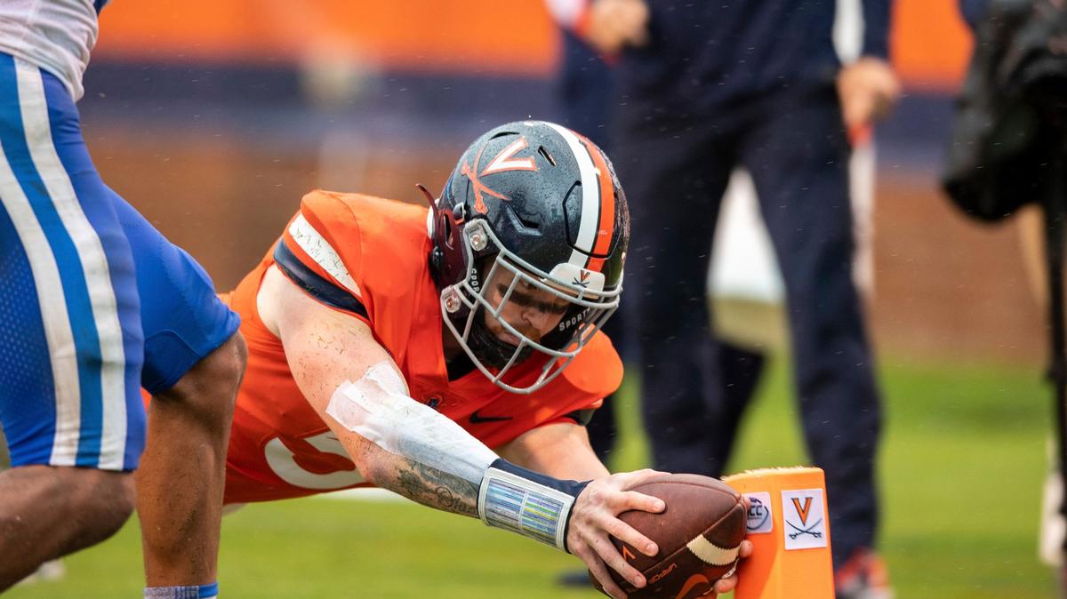Virginia Cavaliers quarterback Brennan Armstrong (5) dives for a touchdown against Duke at Scott Stadium on October 16, 2021 in Charlottesville, Va. On Saturday, January 7, 2023, Armstrong announced he is transferring to N.C. State. (AP Photo/Mike Caudill)