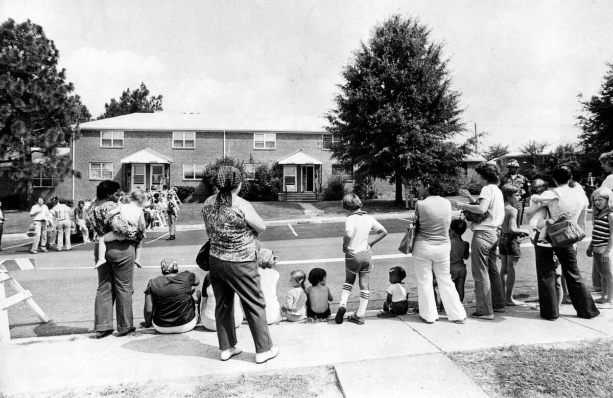 Spectators gather in front of 544 Castle Drive on Ft. Bragg, N.C. before the jury visited the location, August 6, 1979. This was the military housing apartment where the Colette MacDonald and her two children were brutally murdered. Husband Jeffrey MacDonald, a Green Beret doctor, was convicted of the murders.
