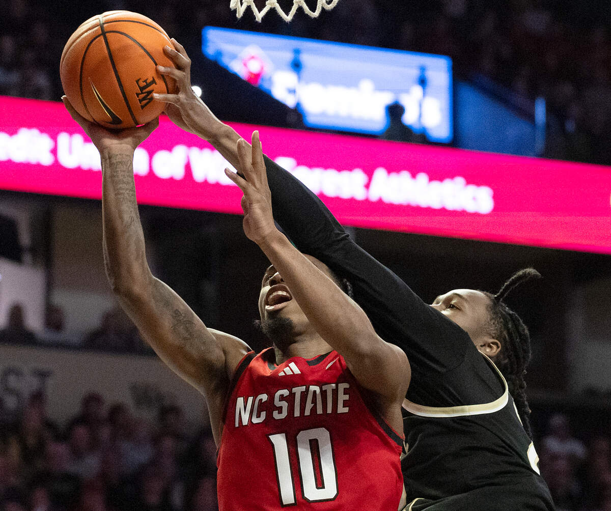 Wake Forest’s Tre’Von Spillers blocks a shot by N.C. State’s Marcus Hill during the second half of the Wolfpack’s 77-59 loss on Saturday, Jan. 4, 2025, at Lawrence Joel Veterans Memorial Coliseum in Winston-Salem, N.C.