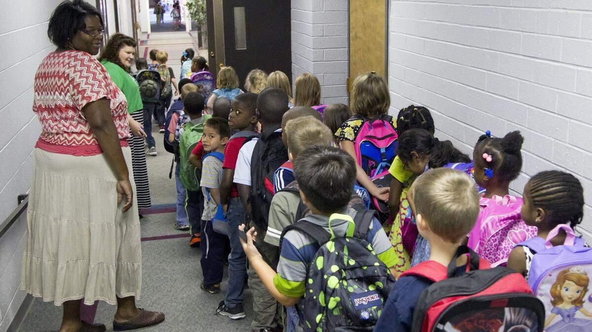 Teachers usher elementary students down the hall as they head for home at the end of the school day on the private school campus of Raleigh Christian Academy in Raleigh on August 21, 2014.  Earlier in the day, a Wake County judged ruled that a state program that provided public funds for private schools was unconstitutional, in part because the law did not set accountability standards for the private schools. In 2015, the state Supreme Court reversed that ruling.