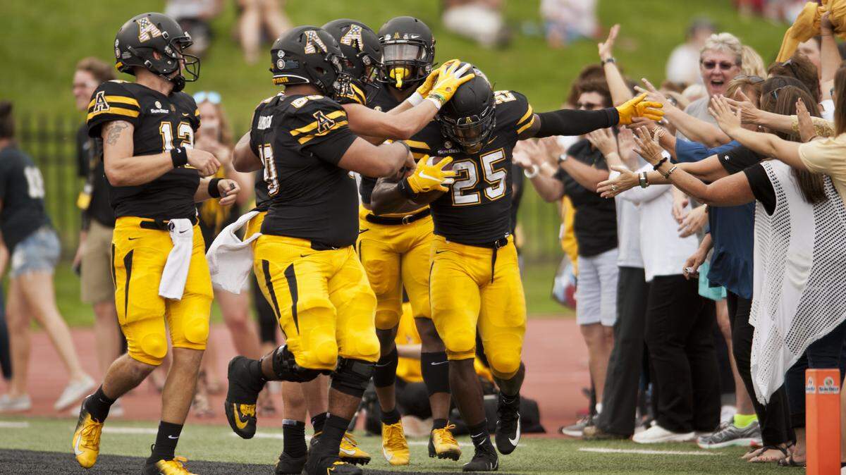 Appalachian State teammates celebrate with Jalin Moore (25) after scoring a first quarter touchdown against Gardner-Webb in an NCAA football game, Saturday, Sept. 22, 2018 at Kidd Brewer Stadium in Boone, N.C. (Walt Unks/The Winston-Salem Journal via AP)