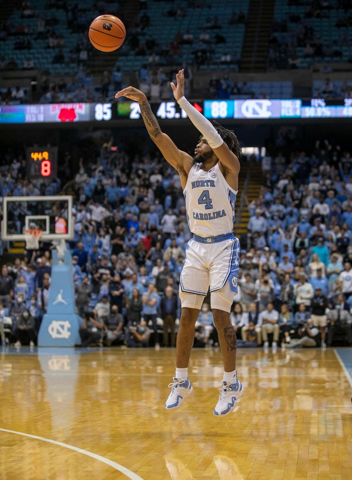 North Carolina’s R.J. Davis (4) launches a three-point shot in the second half against Brown two give the Tar Heels’ a 91-85 lead on Friday, November 12, 2021 at the Smith Center in Chapel Hill, N.C. Davis lead the Tar Heels with 26 points in their 94-87 victory.