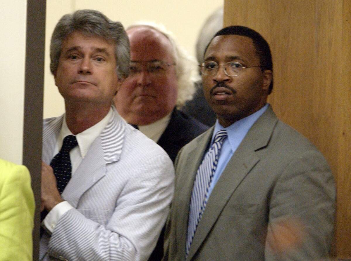 In this file photo, Franklin Freeman (left), chief lobbyist for Gov. Mike Easley, and Kevin Howell, also a legislative liaison for the governor, stand by a rear door to the House Appropriations committee room just before the second vote on funding for the “More at Four” program.