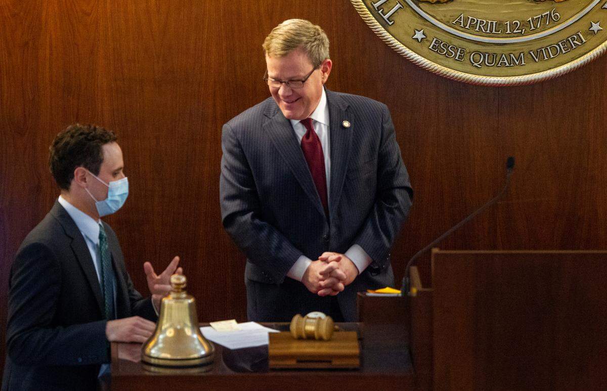 Speaker Tim Moore talks with House Clerk James White as the North Carolina House debates before passing its $1.7 billion COVID-19 response bill, called the Pandemic Response Act, on Thursday, April 30, 2020 at the General Assembly.
