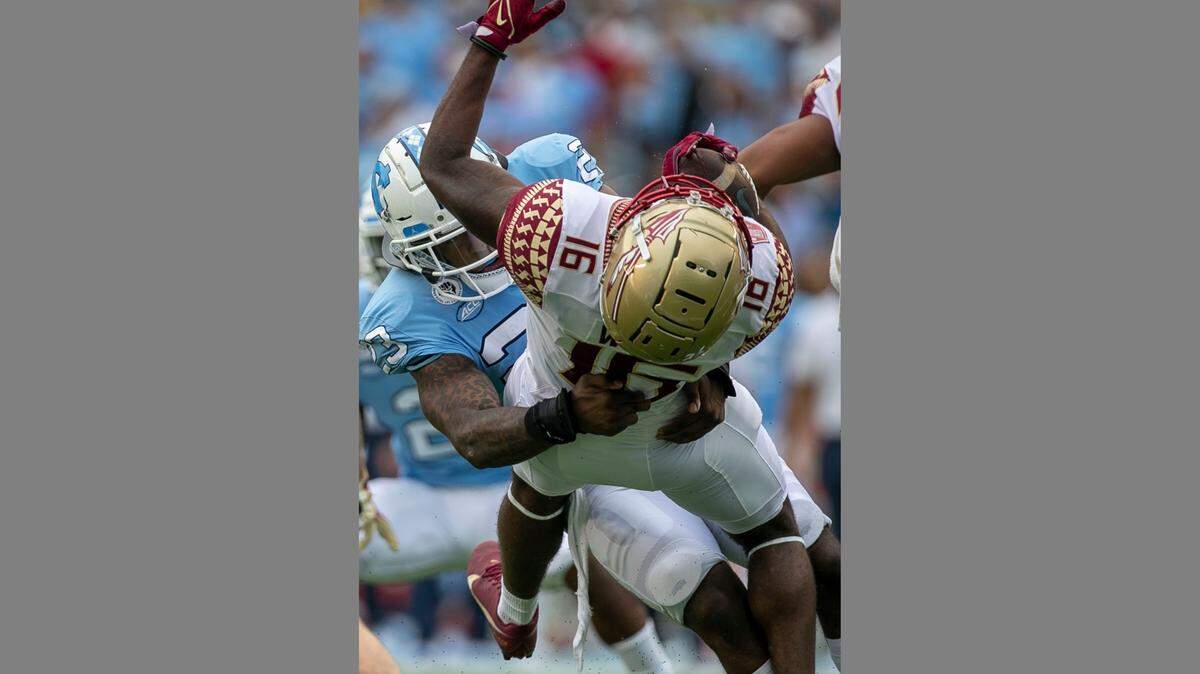 Florida State’s Corey Wren (16) is stopped after a 13-yard return by North Carolina’s Powers Echols (23) on Saturday, Oct. 9, 2021, at Kenan Stadium in Chapel Hill, N.C. Echols was called for targeting on the play and was ejected from the game.