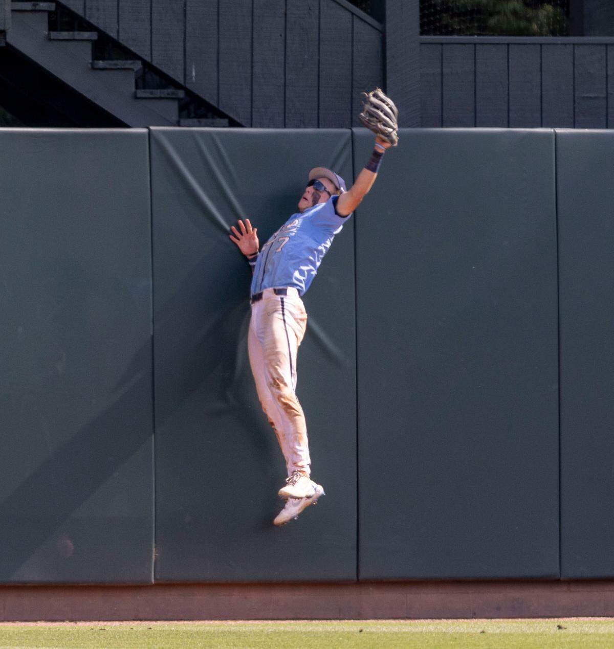 North Carolina centerfielder Vance Honeycutt (7) makes a game saving catch on the wall, after a long ball by Georgia’s Josh McAllister in the bottom of the ninth inning, enabling the Tar Heels to secure a 6-5 victory on Sunday, June 5, 2022 at Boshamer Stadium in Chapel Hill, N.C.