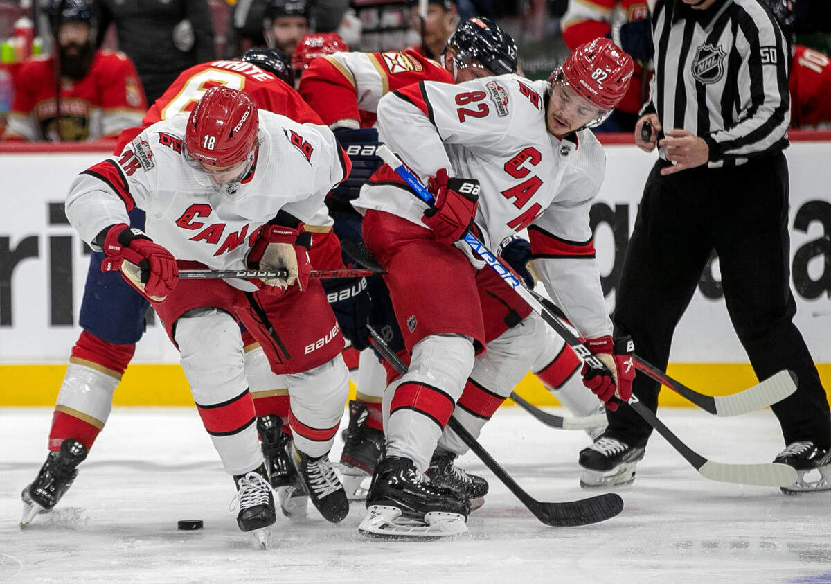 The Carolina Hurricanes Jack Drury (18) and Jesperi Kotkaniemi (82) work to secure the puck on a face-off in the second period against the Florida Panthers during game 4 of the Eastern Conference Finals on Wednesday, May 24, 2023 at FLA Live Arena in Sunrise, Fla.