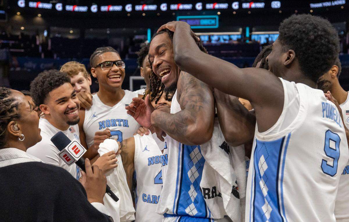 North Carolina forward Jae’Lyn Withers (24) celebrates with his teammates after leading them to a 76-56 victory over Notre Dame, on Wednesday, March 12, 2025 during the second round of the ACC Tournament at Spectrum Center in Charlotte, N.C. Withers scored 21 points, sinking seven three-point baskets.