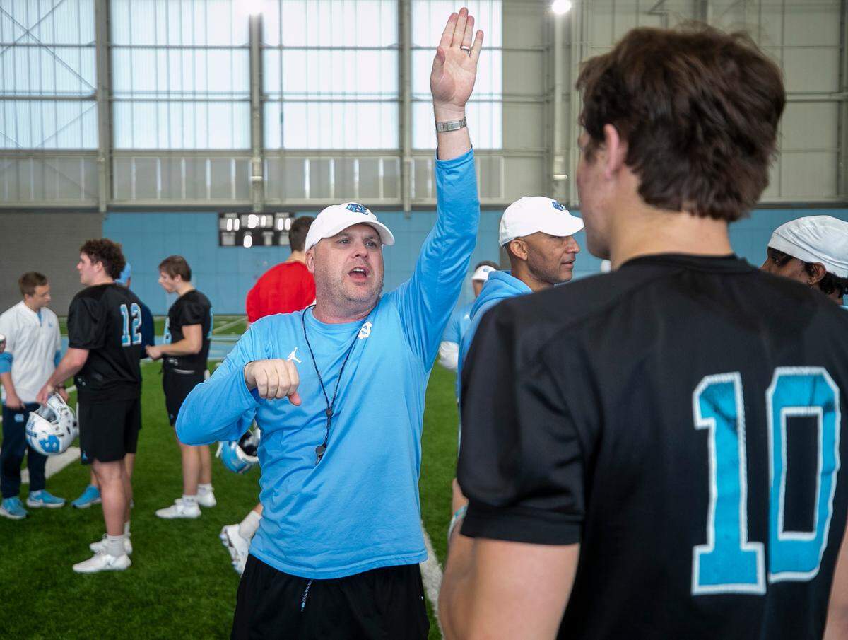 North Carolina offensive coordinator and quarterbacks coach, Chip Lindsey, talks with quarterback Drake Maye (10) during the Tar Heels’ football practice on Tuesday, March 7, 2023 in Chapel Hill, N.C.