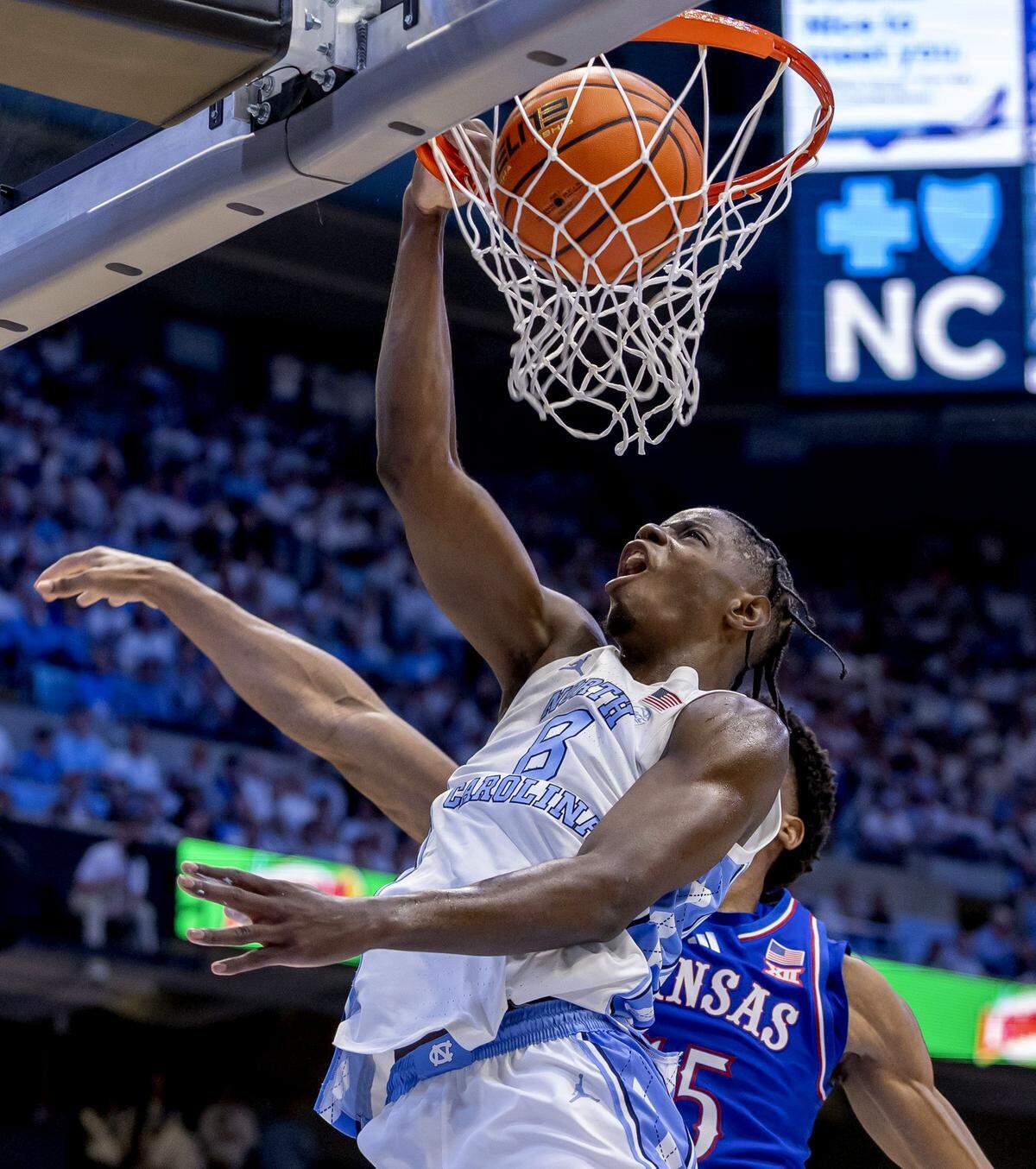 North Carolina forward Caleb Wilson (8) dunks over Kansas forward Bryson Tiller (15) in the first half on Friday, November 7, 2025 at the Smith Center in Chapel Hill, N.C.