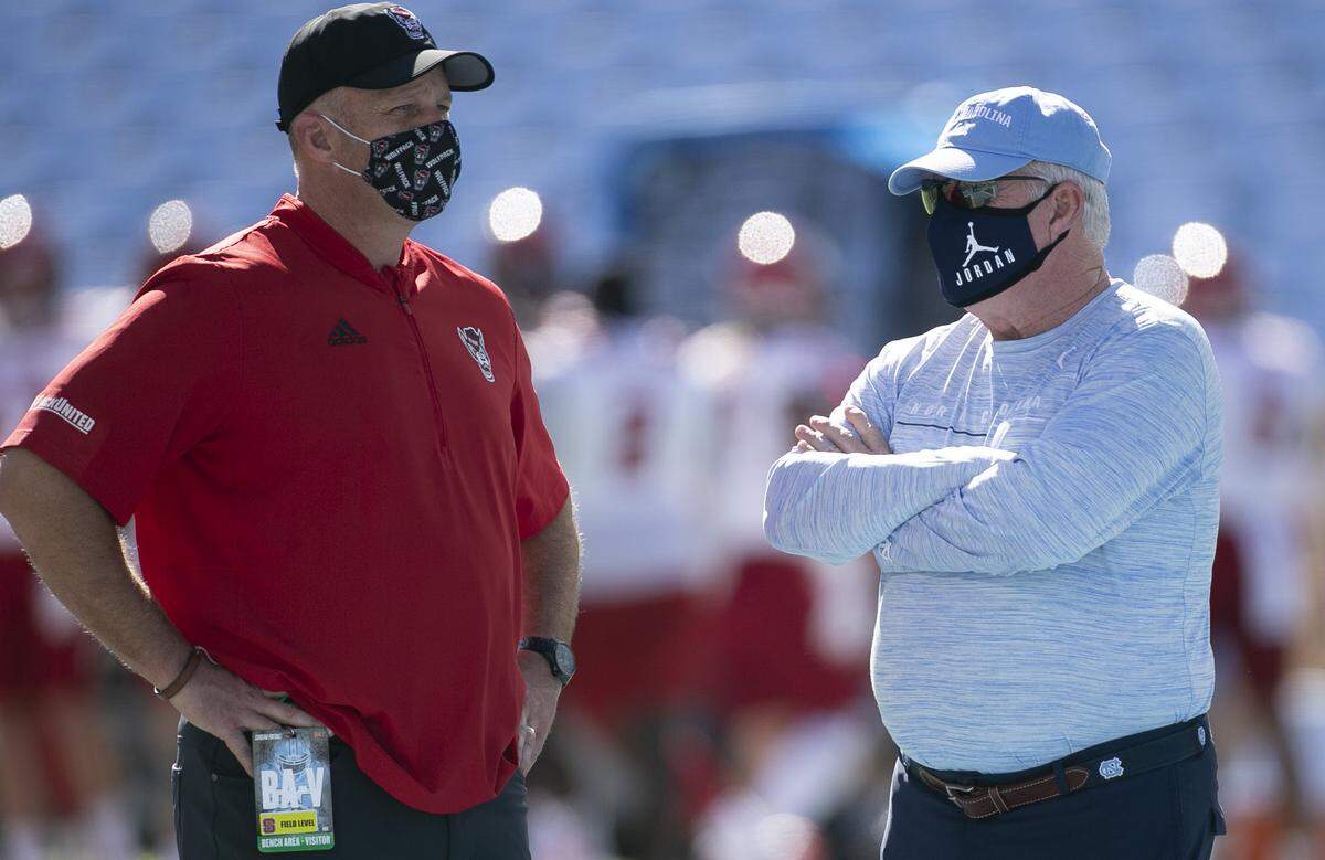 North Carolina coach Mack Brown talks with N.C. State coach Dave Doeren prior to their game at Kenan Stadium on Saturday, October 24, 2020 in Chapel Hill, N.C.