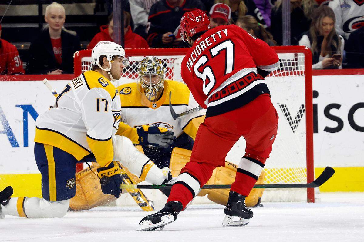 Carolina Hurricanes’ Max Pacioretty (67) has his shot go off the hand of Nashville Predators center Mark Jankowski (17) in front of Predators goaltender Juuse Saros (74) during the first period of an NHL hockey game in Raleigh, N.C., Thursday, Jan. 5, 2023. (AP Photo/Karl B DeBlaker)