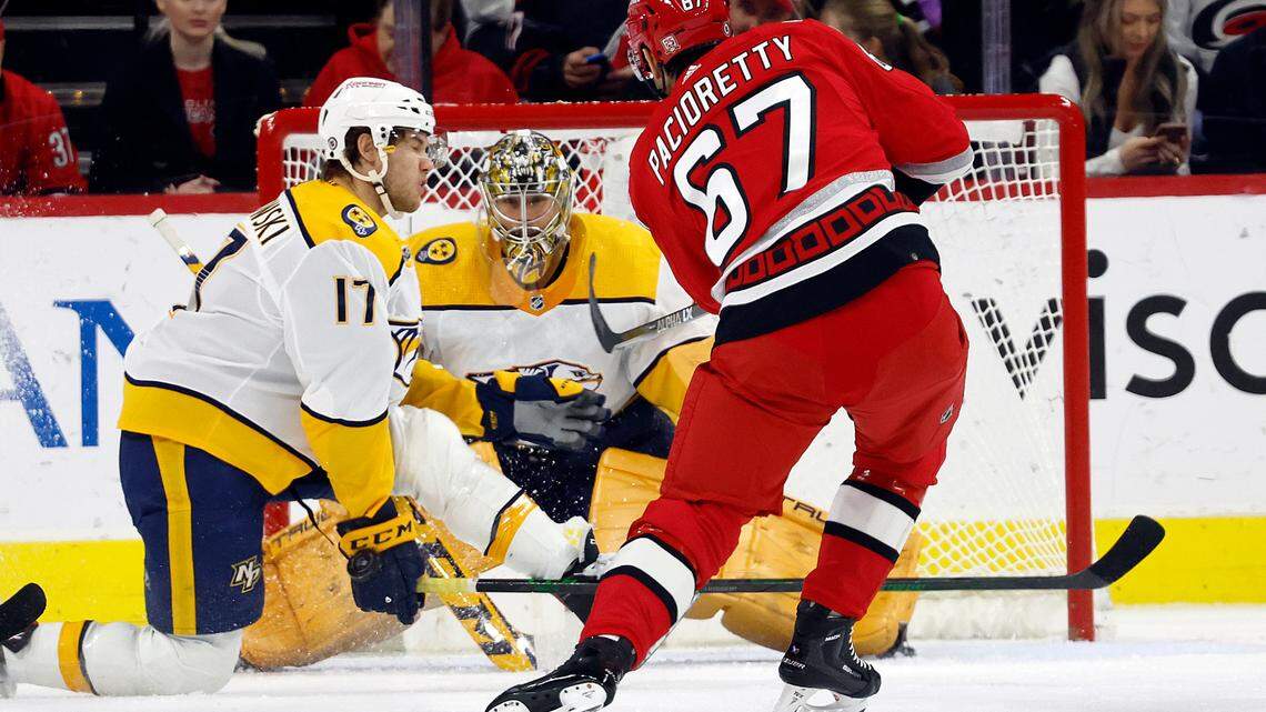 Carolina Hurricanes’ Max Pacioretty (67) has his shot go off the hand of Nashville Predators center Mark Jankowski (17) in front of Predators goaltender Juuse Saros (74) during the first period of an NHL hockey game in Raleigh, N.C., Thursday, Jan. 5, 2023. (AP Photo/Karl B DeBlaker)