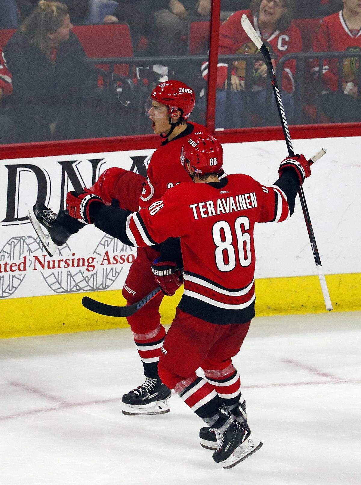 Carolina Hurricanes’ Sebastian Aho (20) celebrates his game winning overtime goal against the Chicago Blackhawks with teammate Teuvo Teravainen (86) during the third period of an NHL hockey game, Monday, Nov. 12, 2018, in Raleigh, N.C. (AP Photo/Karl B DeBlaker)