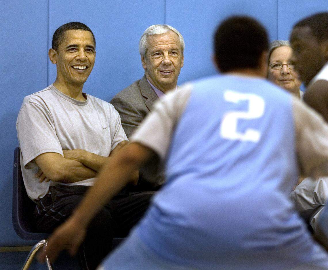 OBAMABBALL12.NEWS.042908.CLL -- Presidential hopeful Senator Barack Obama, left, UNC Head Basketball Coach Roy Williams, center, and his wife, Wanda, watch the UNC men’s team scrimmage during a practice Tuesday morning at the Dean Smith Center in Chapel Hill. Staff Photo by Corey Lowenstein