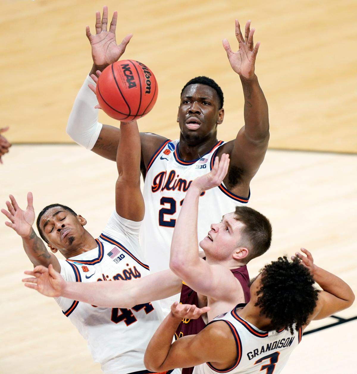 Loyola of Chicago’s Tate Hall, second from right, shoots against Illinois defenders Adam Miller, lower left, Kofi Cockburn, top, and Jacob Grandison (3) during the first half of a college basketball game in the second round of the NCAA tournament at Bankers Life Fieldhouse in Indianapolis Sunday, March 21, 2021. 