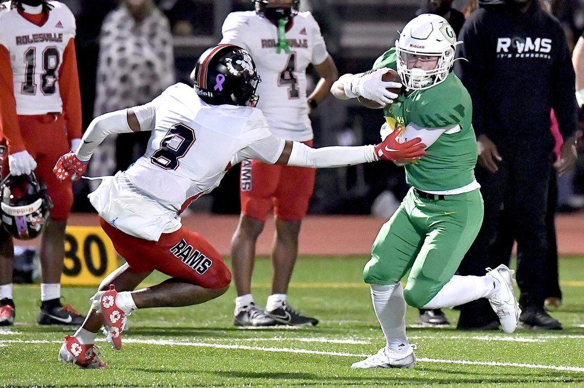 Cardinal Gibbons wide receiver Joey Jonske (11) runs for the first down against Rolesville’s Marion Turner (8) during the first half. The Rolesville Rams and the Cardinal Gibbons Crusaders met in the East Regional Final of the NCHSAA 4A football playoffs in Raleigh, N.C. on December 13, 2024.