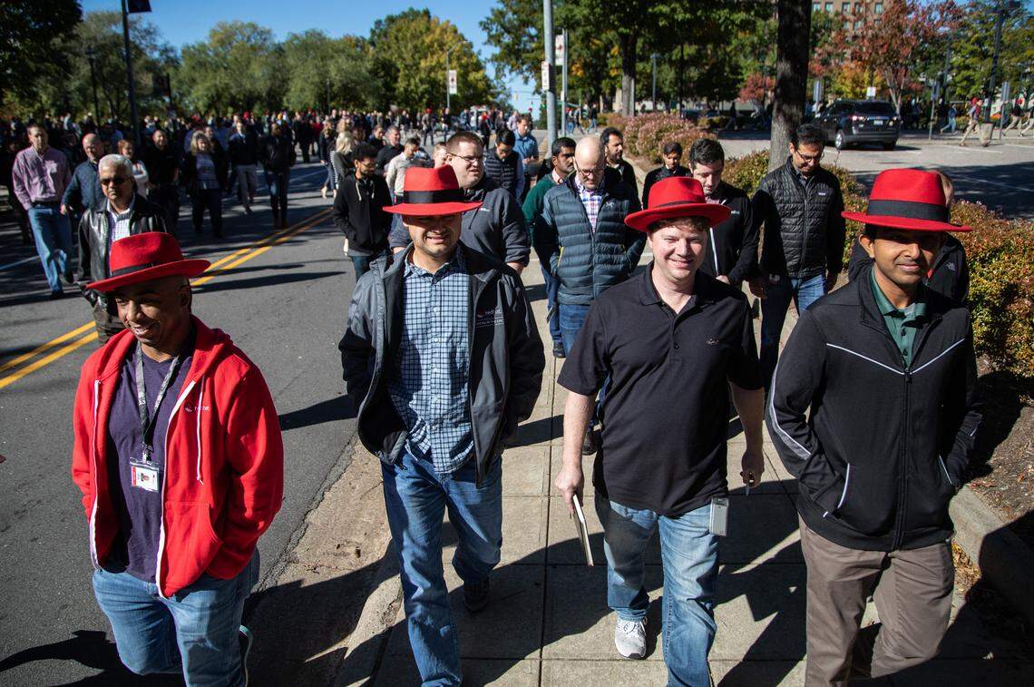 Red Hat employees from left, Landon LaSmith, Chris Chase, Steven Huels and Prasanth Anbalagan walk back to their Raleigh headquarters after a meeting at the Duke Energy Center for the Performing Arts Monday, Oct. 29, 2018. Some employees at the meeting were worried about a culture clash between the two companies.
