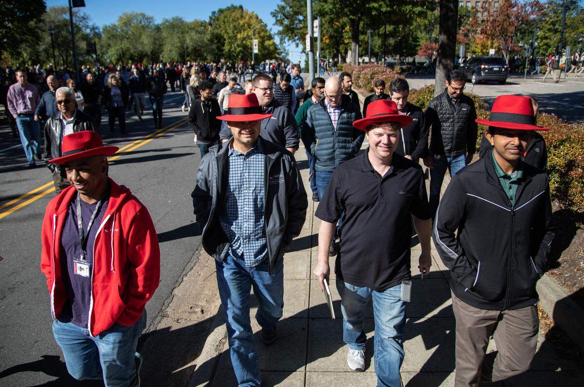 Red Hat employees from left, Landon LaSmith, Chris Chase, Steven Huels and Prasanth Anbalagan walk back to their Raleigh headquarters after a meeting at the Duke Energy Center for the Performing Arts Monday, Oct. 29, 2018. Some employees at the meeting were worried about a culture clash between the two companies.