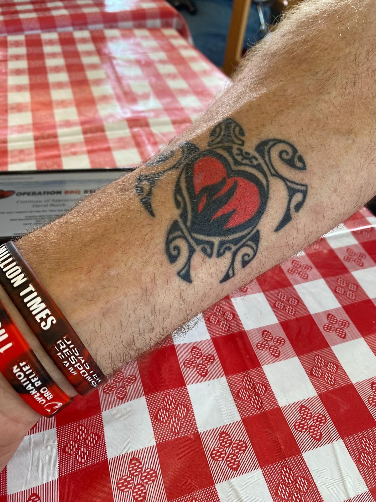 David Lee Burch shows off his new tattoo obtained in Maui while volunteering with Operation BBQ Relief.