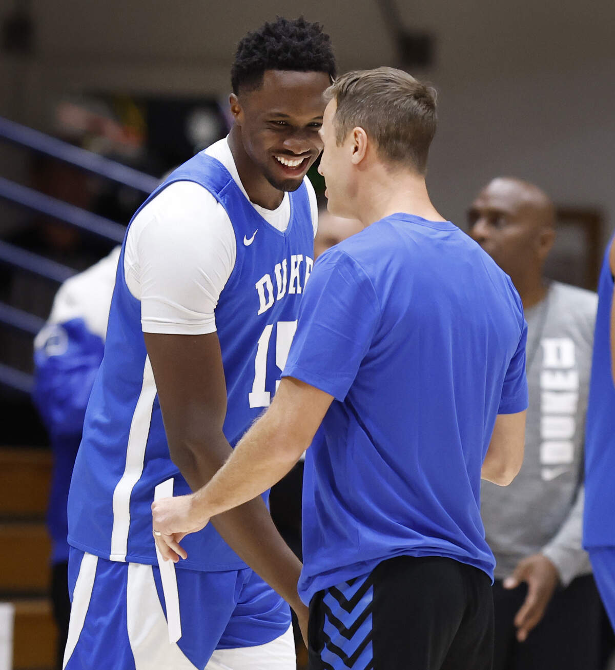 Duke’s Ifeanyi Ufochukwu (15) laughs with head coach Jon Scheyer during the Blue Devils’ open practice at Cameron Indoor Stadium in Durham, N.C., Tuesday, August 5, 2025.