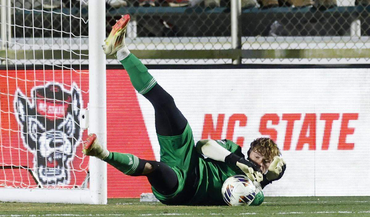 N.C. State's Logan Erb (1) makes the save during the first half of N.C. State’s game against Washington in the 2025 Men’s Soccer National Championship at WakeMed Soccer Park in Cary, N.C., Monday, Dec. 15, 2025.