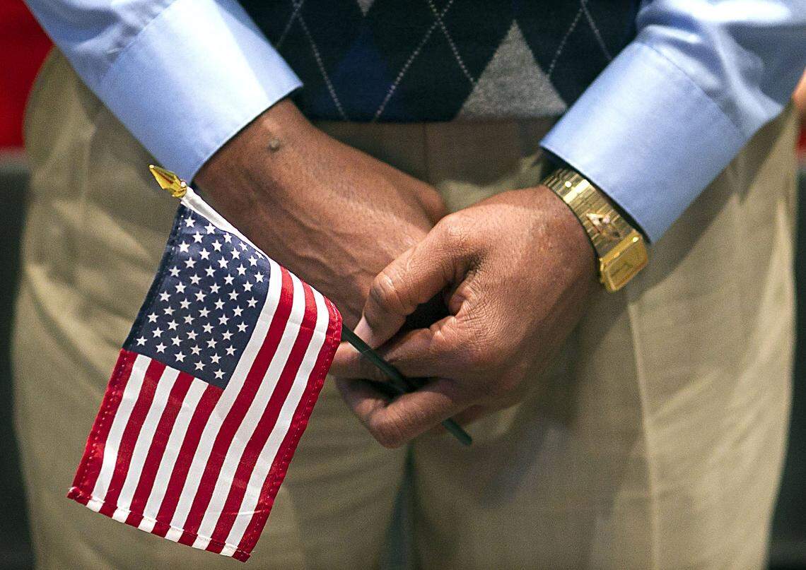 Each of the 111 people who were awarded American Citizenship were given an American Flag by the Daughters of the America Revolution during a ceremony at the Raleigh Convention Center on Friday, October 9, 2015 in Raleigh.