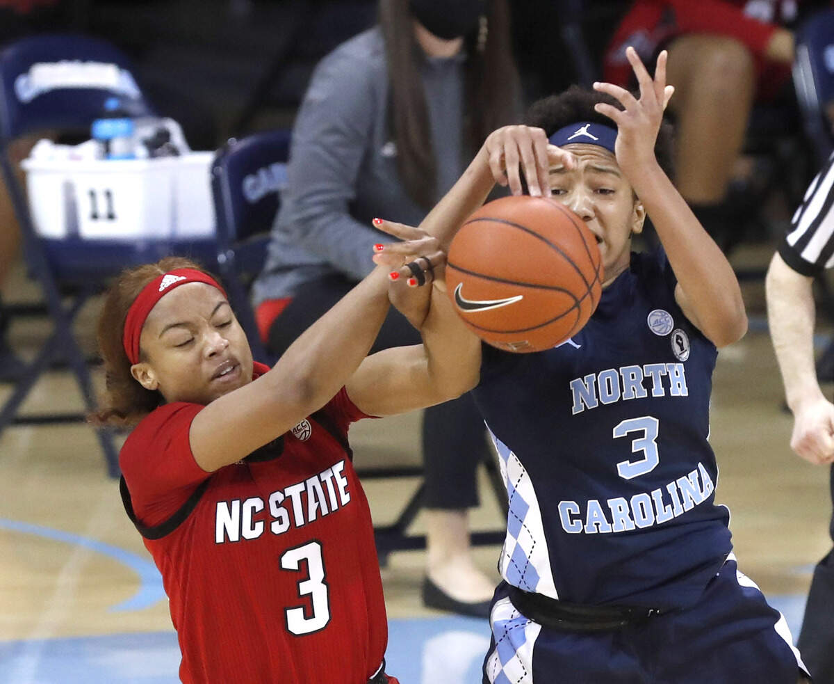 N.C. State’s Kai Crutchfield (3) and North Carolina’s Kennedy Todd-Williams (3) go after the ball during the first half of N.C. State’s game against UNC at Carmichael Arena in Chapel Hill, N.C., Sunday, February 7, 2021.