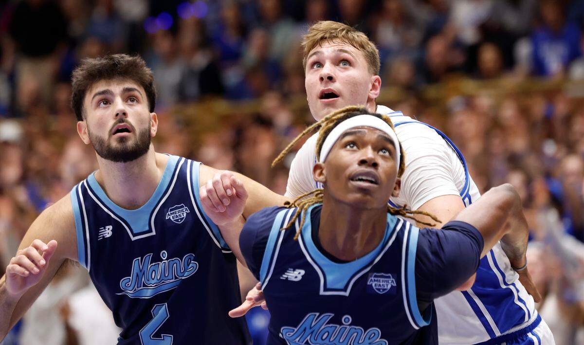 Duke’s Cooper Flagg, back, fights for position during a free throw with Maine’s Christopher Mantis, front center, and Quion Burns, left, during the first half of the Blue Devils game against the Black Bears at Cameron Indoor Stadium on Nov. 4, 2024.