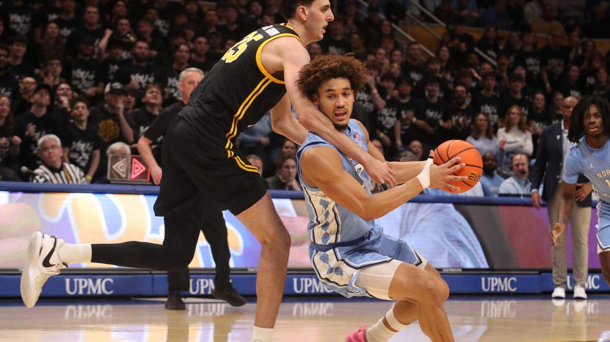 North Carolina Tar Heels guard Seth Trimble (right) handles the ball against Pittsburgh Panthers forward Guillermo Diaz Graham (25) during the first half the Petersen Events Center.