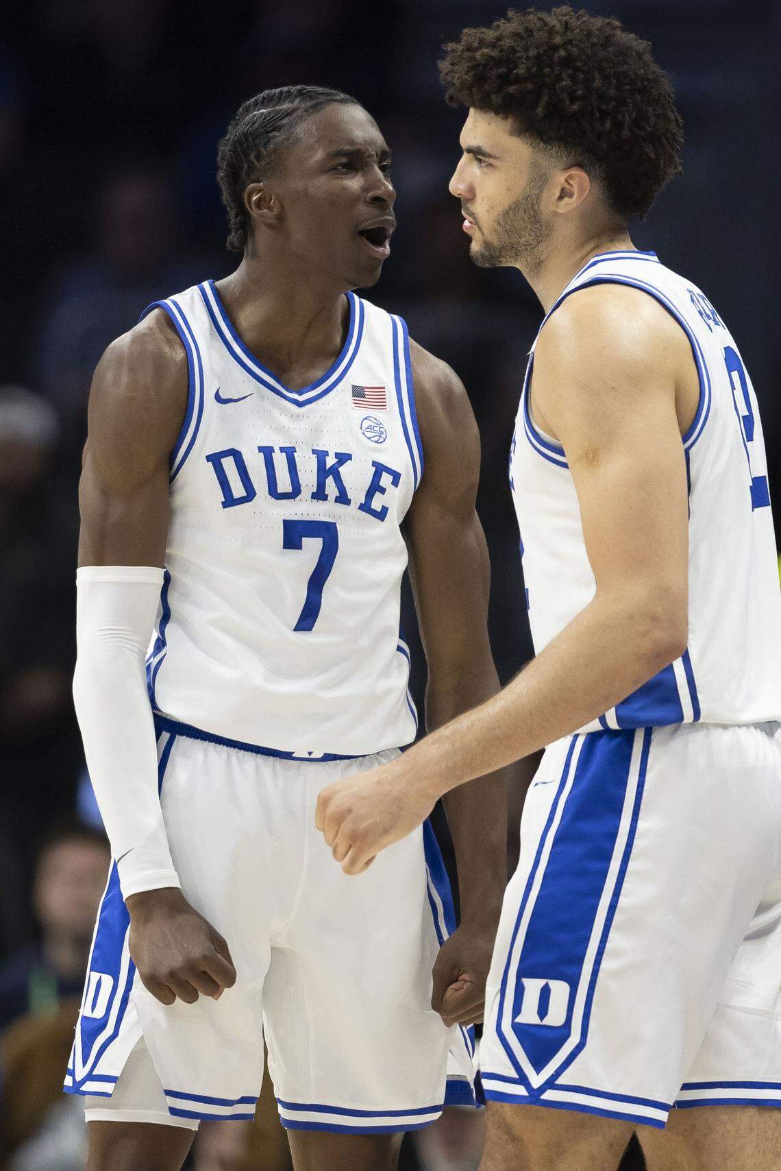 Duke guard Dame Sarr (7) chest bumps teammate Cameron Boozer (12)  after a turnover in the first half against Virginia on Saturday, March 14, 2026, during the ACC Tournament Championship at Spectrum Center in Charlotte, N.C.