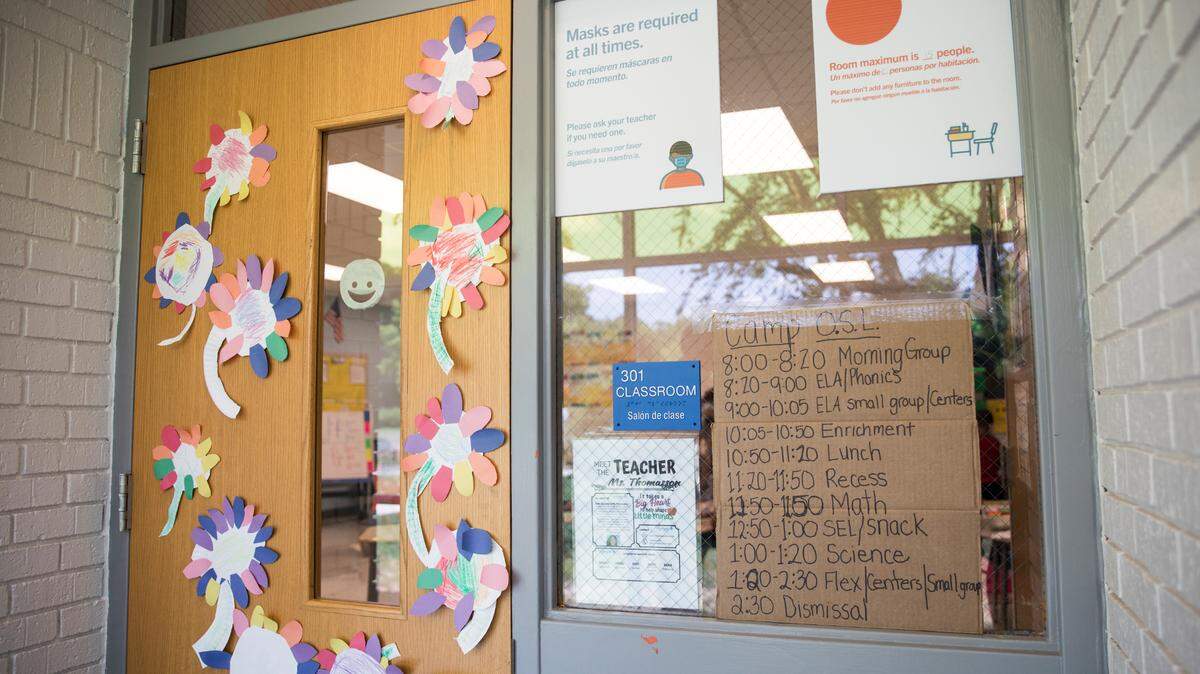 A daily schedule is posted outside a classroom a Eno Valley Elementary School in Durham, N.C., pictured here on Monday, June 21, 2021. The program, referred to as “Camp Eno Valley,” is geared towards providing a summer camp environment for Durham students who may have fallen behind in school during the COVID-19 pandemic.