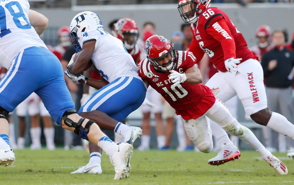 N.C. State safety Tanner Ingle (10) pressures Duke running back Deon Jackson (4) during the first half of N.C. State’s game against Duke at Carter-Finley Stadium in Raleigh, N.C., Saturday, Oct. 17, 2020.