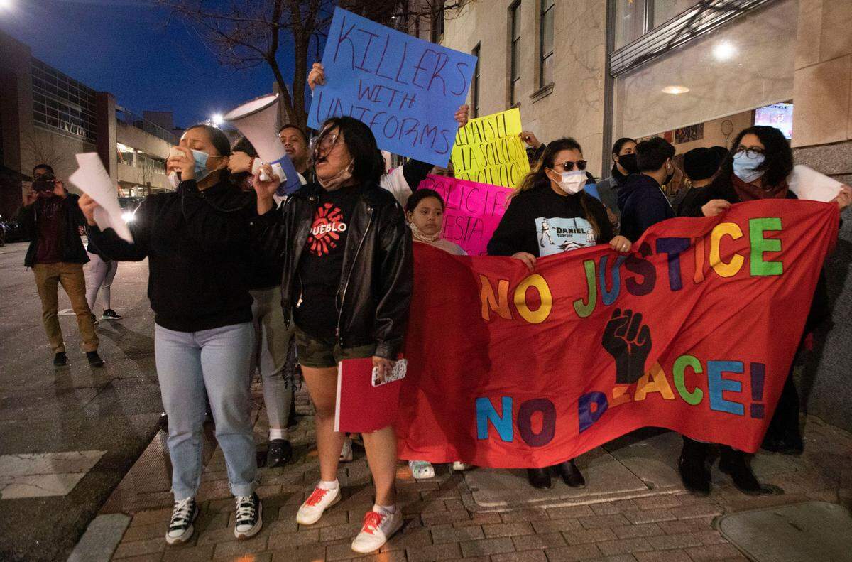 Organizers, advocates and the wife of Daniel Turcios, who was shot and killed by Raleigh police in January, march through downtown Raleigh, N.C. on Thursday, Feb. 10, 2022.
