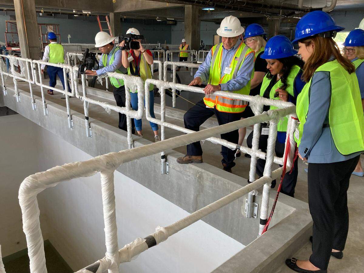 N.C. Department of Environmental Quality Secretary Elizabeth Biser, right, and U.S. EPA Assistant Administrator Radhika Fox tour the Wilmington-area Cape Fear Public Utility Authority’s under-construction granular activated carbon filters in 2022. Fox, who oversees the EPA Office of Water, was the agency leader who announced lifetime health advisory levels for four “forever chemicals” at a conference.