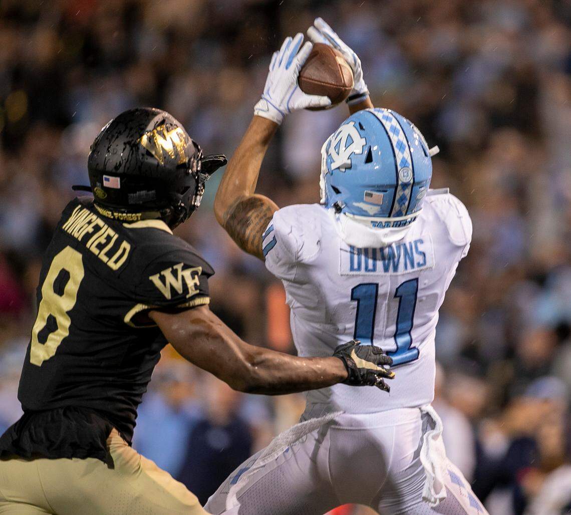 North Carolina’s Josh Downs (11) pulls in a 20-yard pass from quarterback Drake Maye over Wake Forest’s Isaiah Wingfield (8) to give the Tar Heels a 27-21 lead in the second quarter on Saturday, November 12, 2022 at Truist Field in Winston-Salem, N.C.