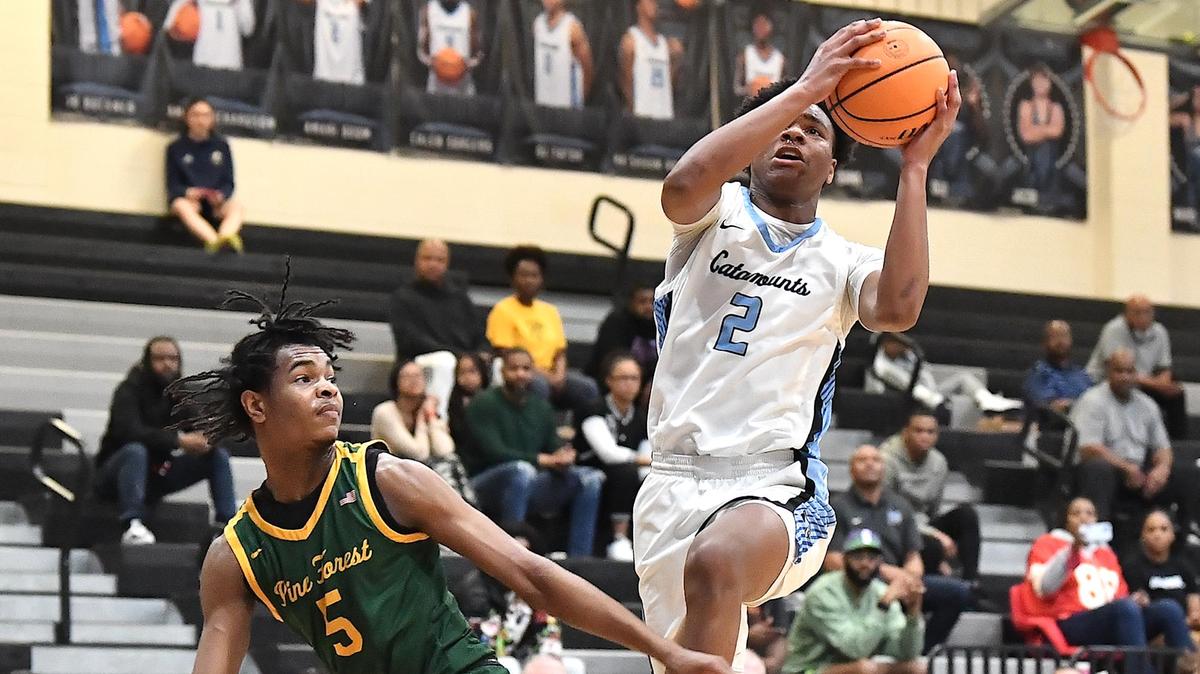 Panther Creek’s Amari Odom (2) goes for the layup against Pine Forest’s Howard Herbert (5) in the first half. The Panther Creek Catamounts and the Pine Forest Trojans met in a NCHSAA 4A first round basketball playoff game in Cary, N.C. on February 21, 2023.