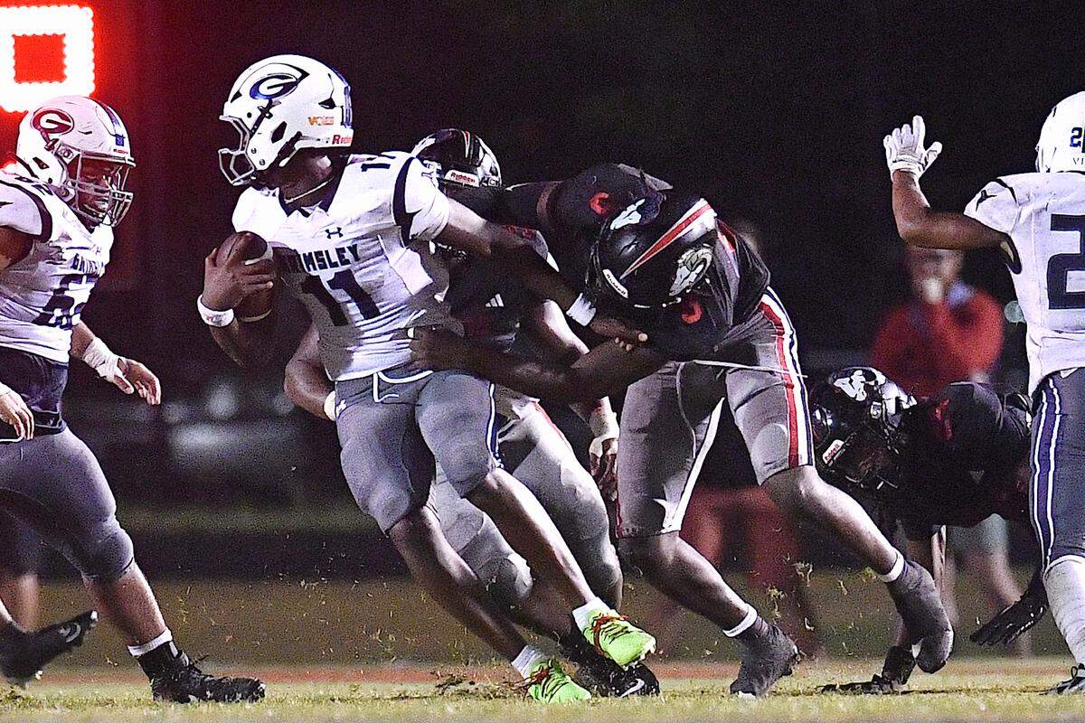 Rolesville’s Zavion Griffin-Haynes (9) grapples and sacks Grismley quarterback Faizon Brandon (11) during the second half. The Rolesville Rams and the Greensboro Grimsley Whirlies met in a non-conference football game in Rolesville, N.C. on August 30, 2024.