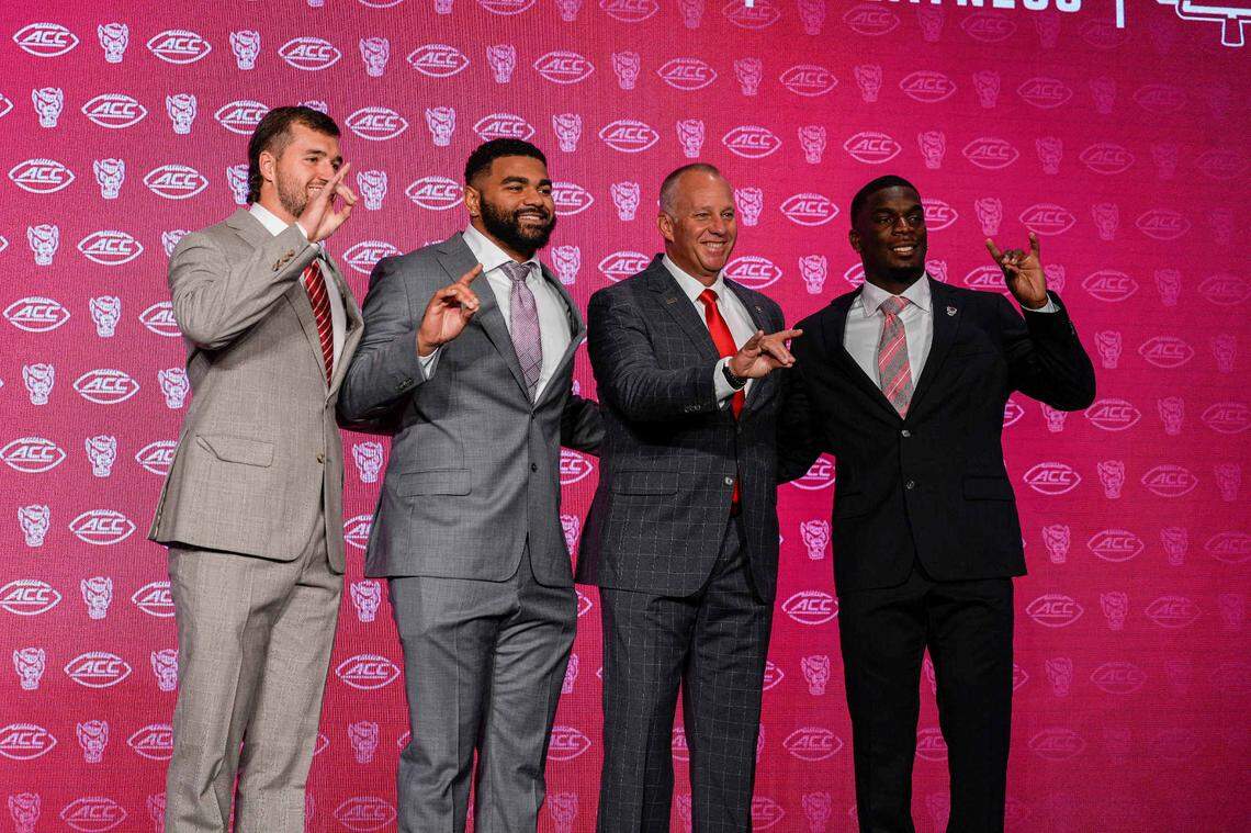 Jul 25, 2024; Charlotte, NC, USA; North Carolina State Wolfpack quarterback Grayson McCall, defensive end Davin Vann, head coach Dave Doeren and running back Jordan Waters during the ACC Kickoff at Hilton Charlotte Uptown. Mandatory Credit: Jim Dedmon-USA TODAY Sports