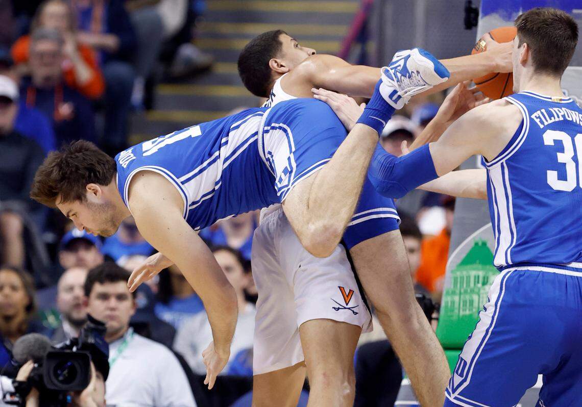 Duke’s Ryan Young (15) fouls Virginia’s Kadin Shedrick (21) during the second half of Duke’s 59-49 victory over Virginia to win the ACC Men’s Basketball Tournament in Greensboro, N.C., Saturday, March 11, 2023.