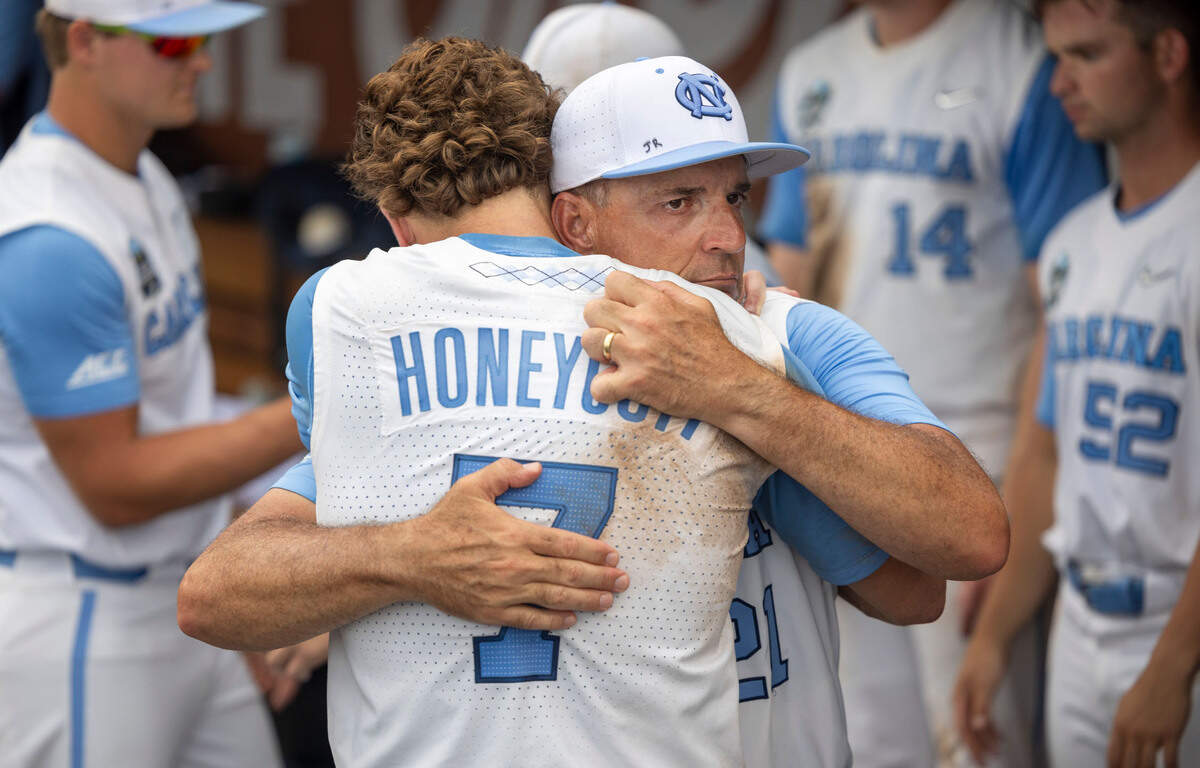 North Carolina coach Scott Forbes embraces outfielder Vance Honeycutt (7) following the Tar Heels’ season ending 9-5 loss to Florida State in game nine of the College World Series on Tuesday, June 18, 2024 at Charles Schwab Field in Omaha, Nebraska.