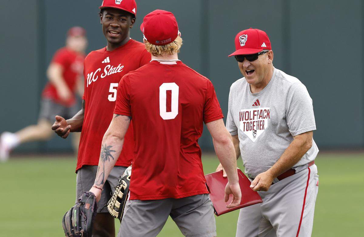 N.C. State head baseball coach Elliott Avent laughs with Sherman Johnson (5) and Luke Nixon (0) during their practice at Doak Field Tuesday, May 26, 2026.