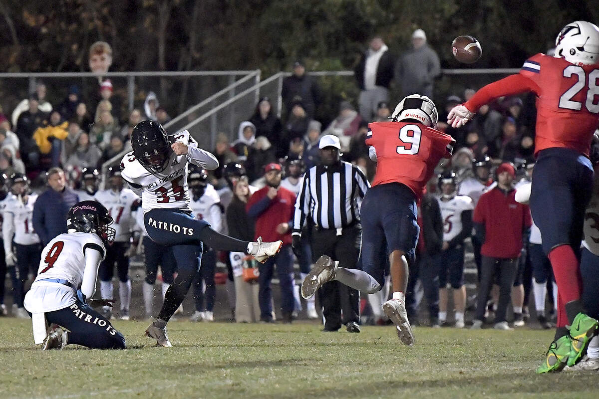 Jordan’s Caden Rice (9) dives and deflects the field goal attempt by Apex Friendship kicker Michael Markulic (35) during the second half. The Apex Friendship Patriots and the Durham Jordan Falcons met in the second round of the NCHSAA 4A playoffs in Durham, N.C. on November 22, 2024.