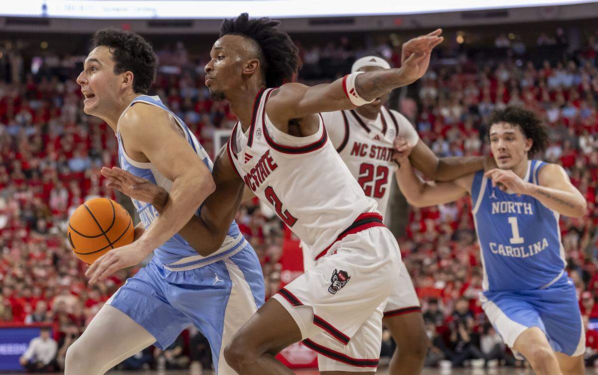 N.C. State guard Paul McNeil Jr. (2) tries for a steal from North Carolina guard Luka Bogavac (44) in the second  half on Tuesday, February 17, 2026 at Lenovo Center in Raleigh, N.C.