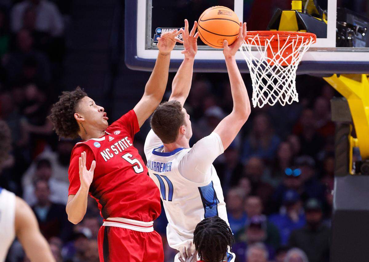 N.C. State’s Jack Clark (5) defends Creighton’s Ryan Kalkbrenner (11) during the first half of N.C. State’s game against Creighton in the first round of the NCAA Tournament at Ball Arena in Denver, Colo., Friday, March 17, 2023.
