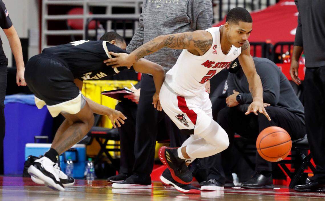 N.C. State’s Shakeel Moore (2) brings the ball upcourt past Wake Forest’s Daivien Williamson (4) during the second half of N.C. State’s 72-67 victory over Wake Forest at PNC Arena in Raleigh, N.C., Wednesday, January 27, 2021.