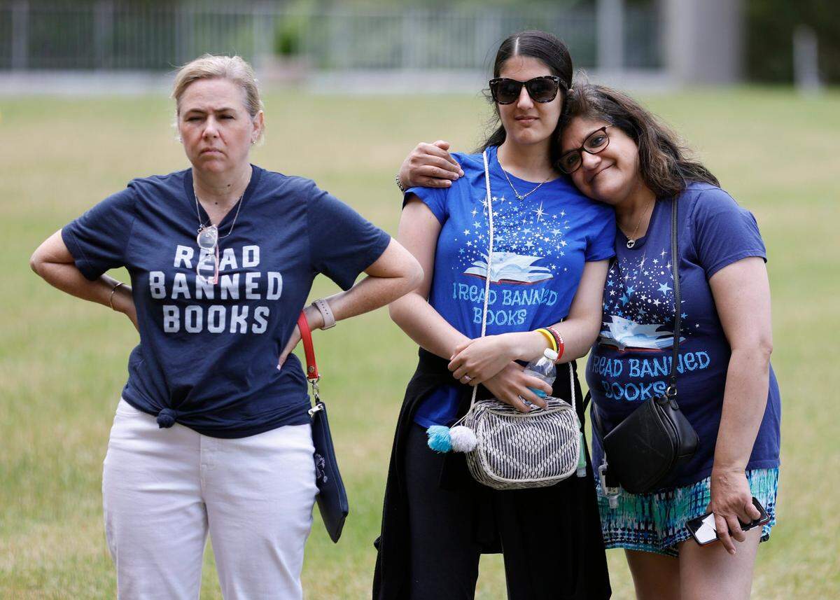 From left, Lynn Edmonds, candidate for Wake County School Board, and Leah Krevat and her mom Madhavi Krevat listen to a reading during a ‘Celebration of Banned Books’ at Halifax Mall in downtown Raleigh, N.C., Saturday, May 7, 2022.