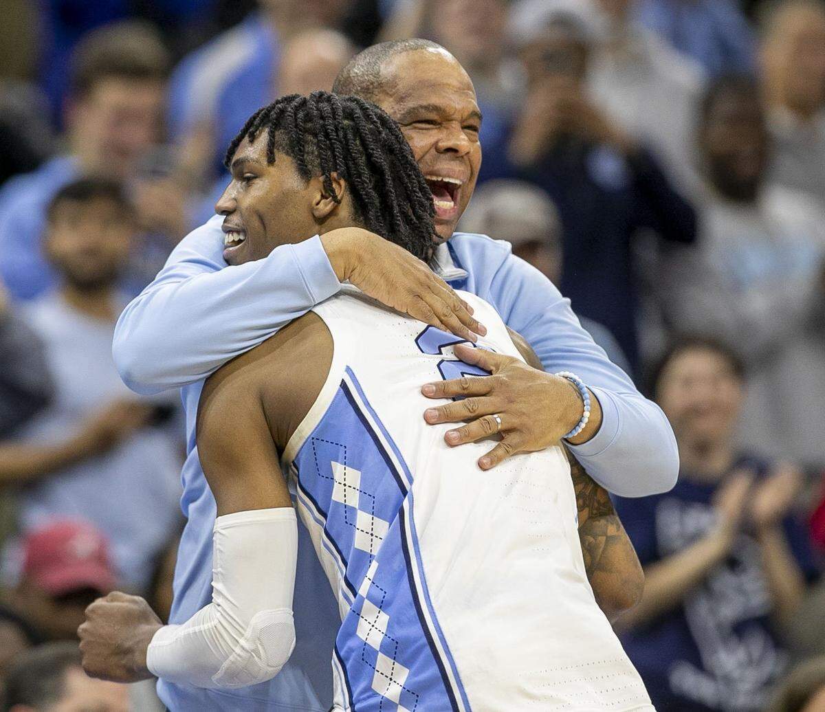 North Carolina coach Hubert Davis embraces Caleb Love (2) as Davis takes his starters out of the game, after securing their victory over Saint Peter’s in the NCAA East Regional final on Sunday, March 27, 2022 at Wells Fargo Center in Philadelphia, Pa. 